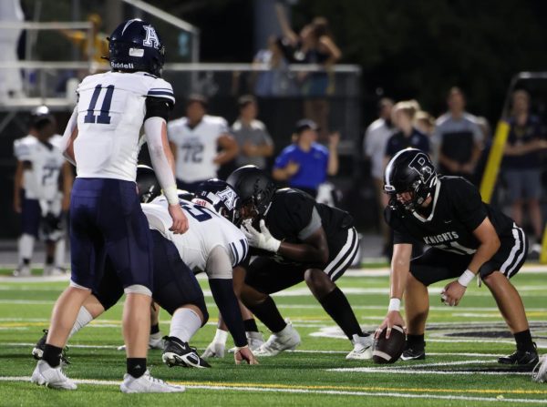 The 2024-2025 football team lines up for a play.