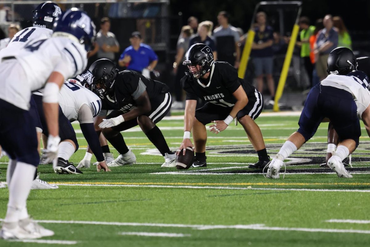 Evan Carlisle ('26) stands ready at the line of scrimmage. 