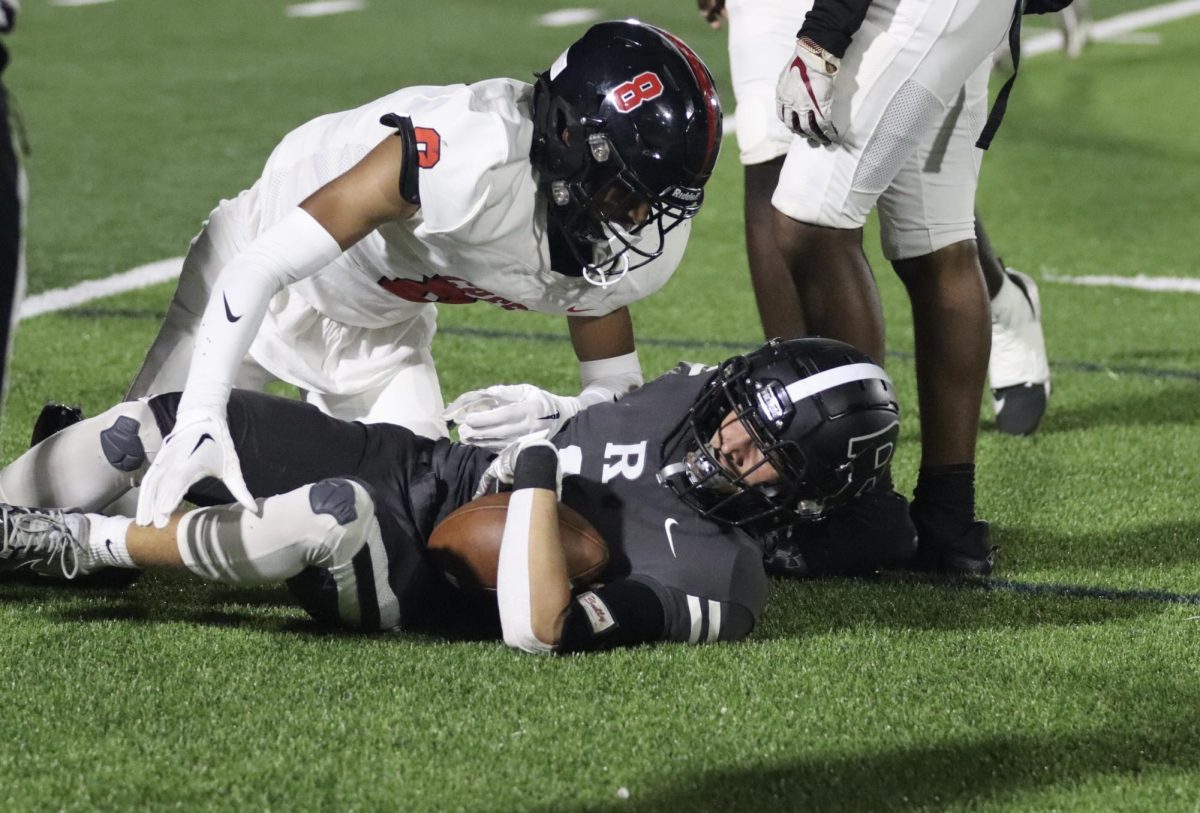 A Robinson player being tackled by a Strawberry crest linemen.