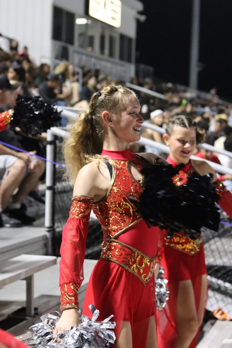 Starlet Lindsey McIntire dances to stand tunes during the last quarter of the homecoming game.