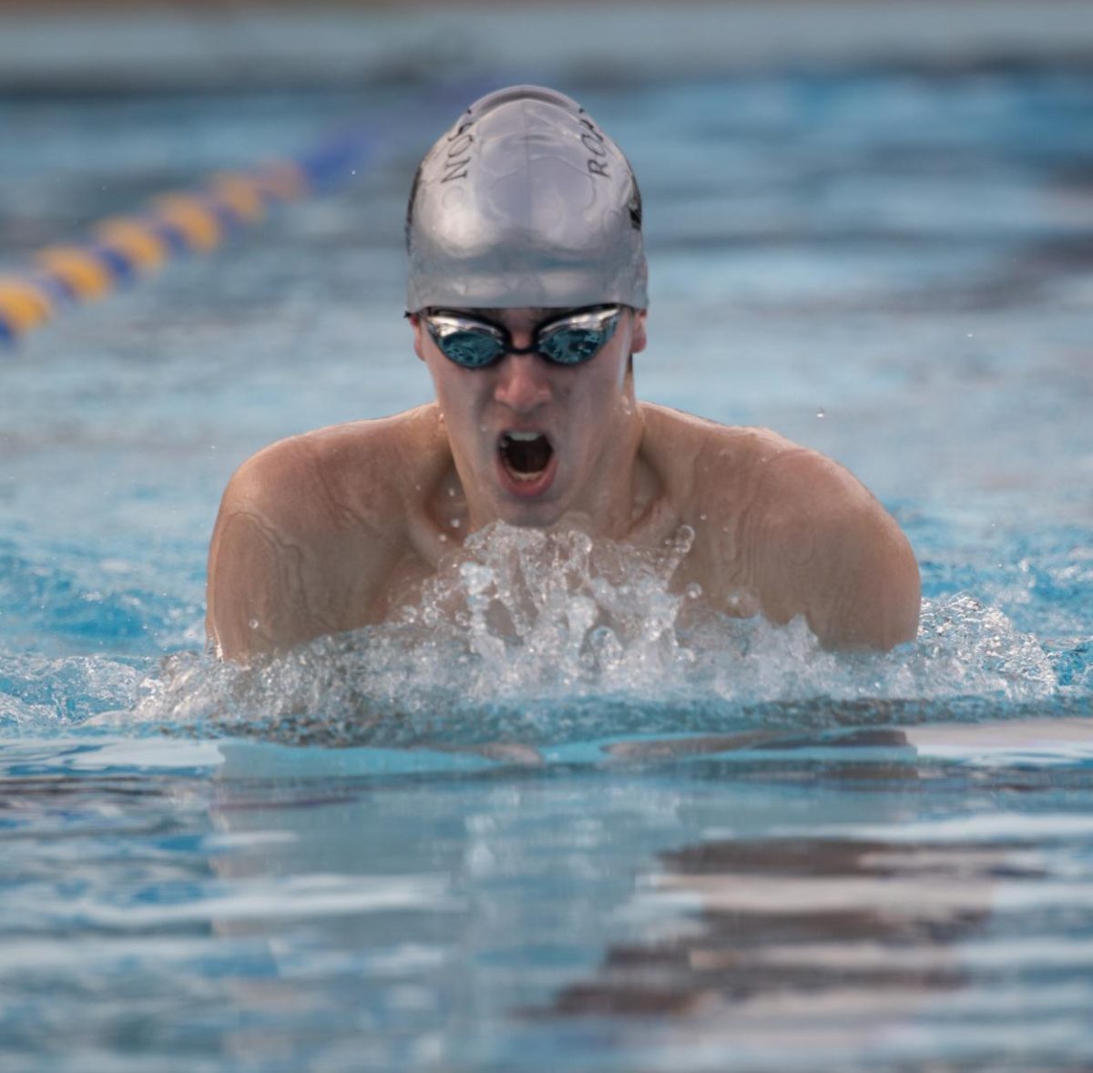 Senior William Tate catching his breath while swimming breast stroke against Plant.