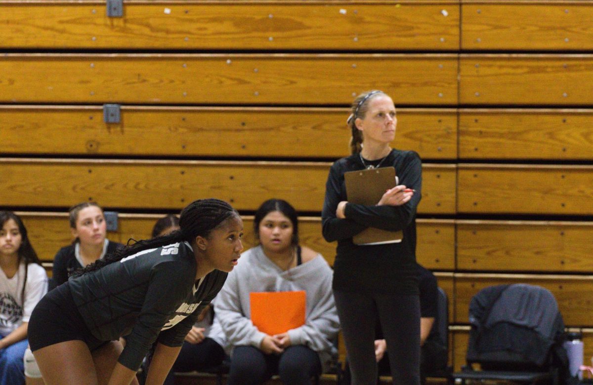 Coach Katrina Clay watching as Kaelyn Klaiber ('27) waits for the ball, during match against Armwood.