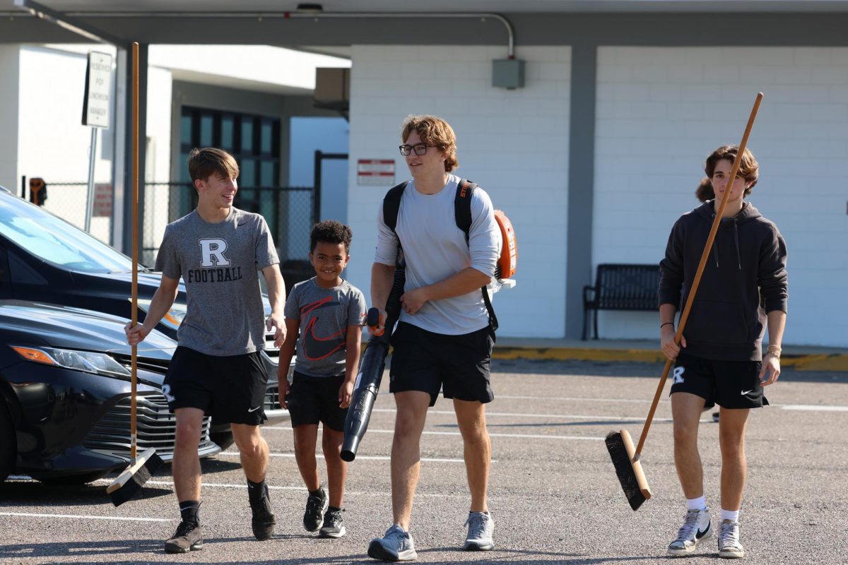 Tiberius Reuss ('26) walks towards the football field with his teammates to clean up the debris from Hurricane Milton. 