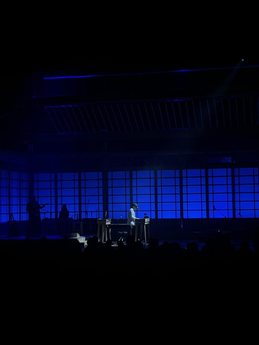 Rex Orange County playing a song on the piano. 