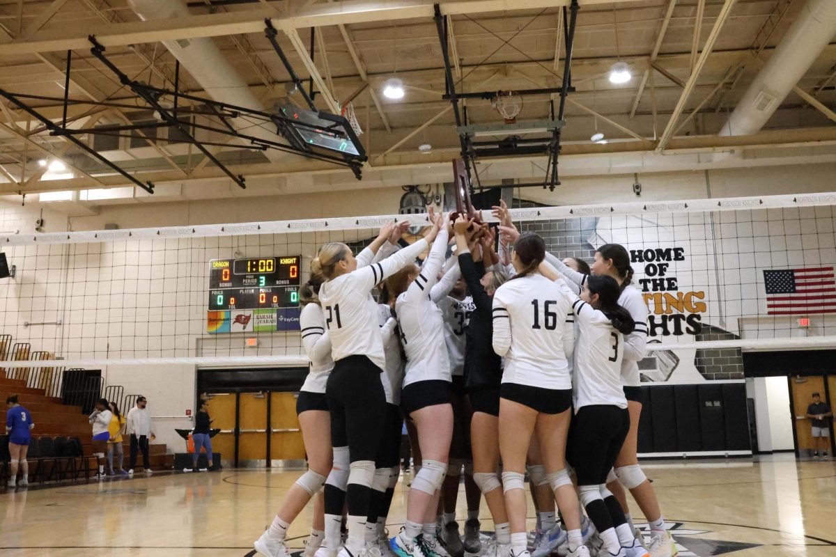 Varsity Volleyball team celebrating after winning the district 10 Finals. 