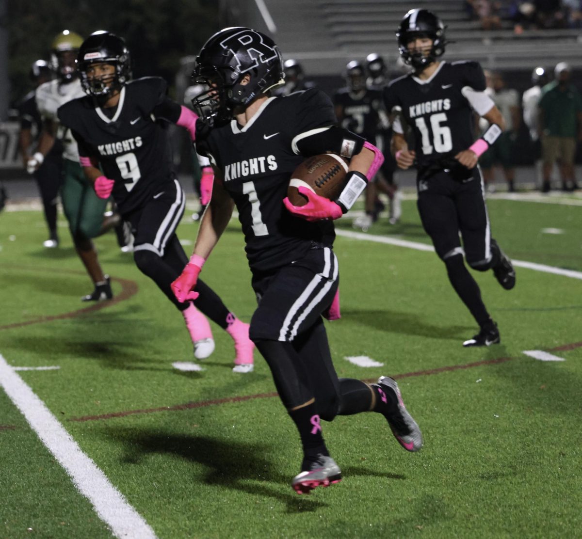 Xander Logan ('25) runs down the football field at an RHS home game.