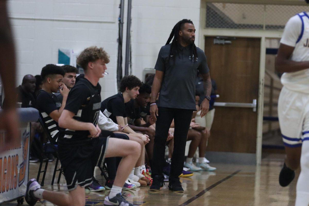 Coach Terrence Briggs watches the boy's basketball game against Jefferson, evaluating their plays.