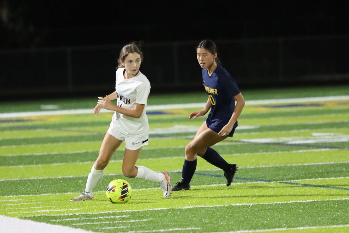 Lucy Borunda ('27) racing down the soccer field.