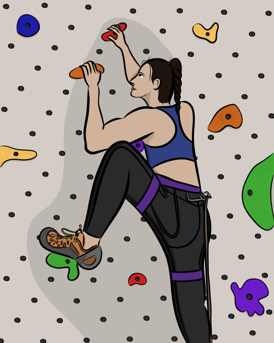 A girl climbing an indoor rock climbing wall.