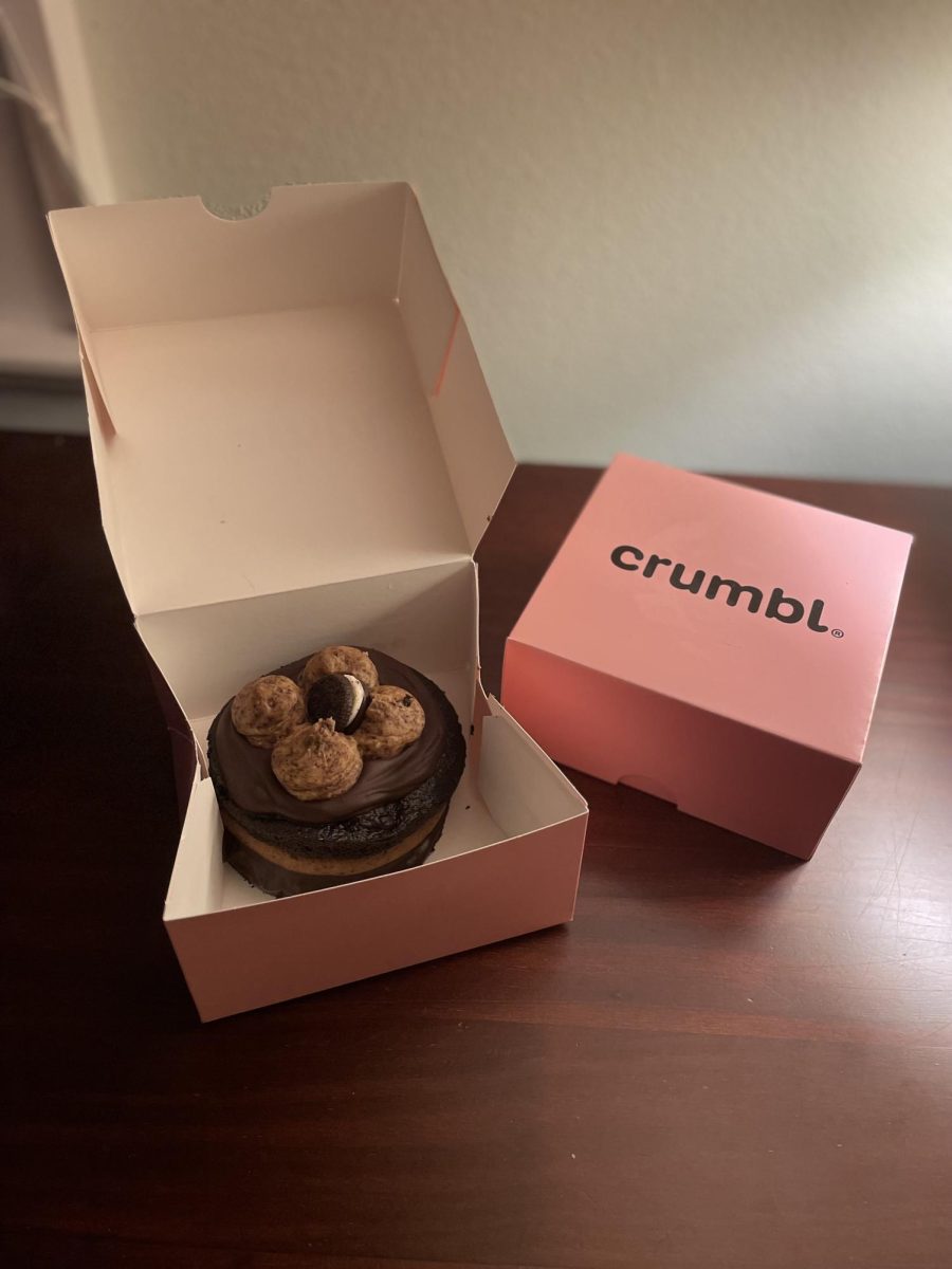 The trademark boxes of Crumbl Cookie displaying the Cookies & Creme Cake.