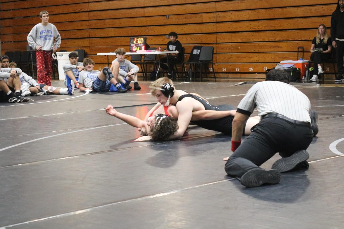 Hudson student being pinned down by Junior wrestler and Robinson Student, Arron McCarty ('26). 