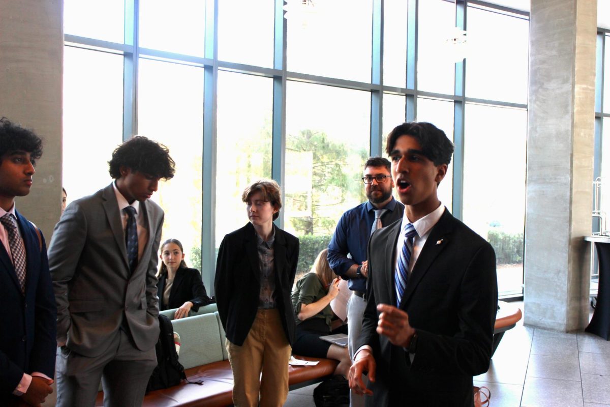 Ayan Nallemshetty speaks alongside Robinson's Speech and Debate team. 