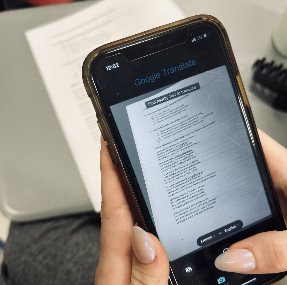A student using google translate's photo feature to cheat on their french test.