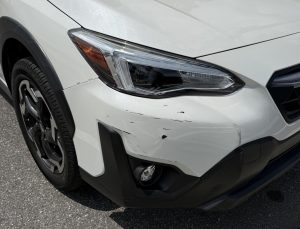 Damage done to a student's car after hitting another car in a Publix parking lot. 