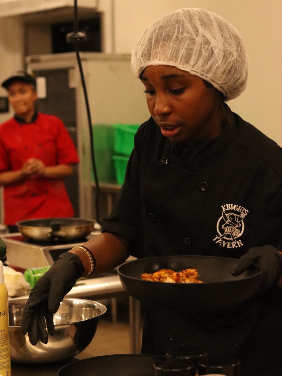 Jaleah Williams ('25) cooks her dish for the competition. "Honestly my thoughts were everywhere when I had to come up with the dish, but I decided to incorporate a lot of veggies for color, and I wanted it to be healthy and refreshing," Williams said.