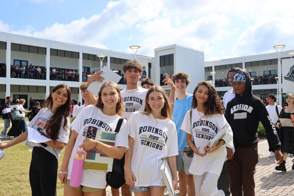 Traditional senior class friend group poses up during the clap out.