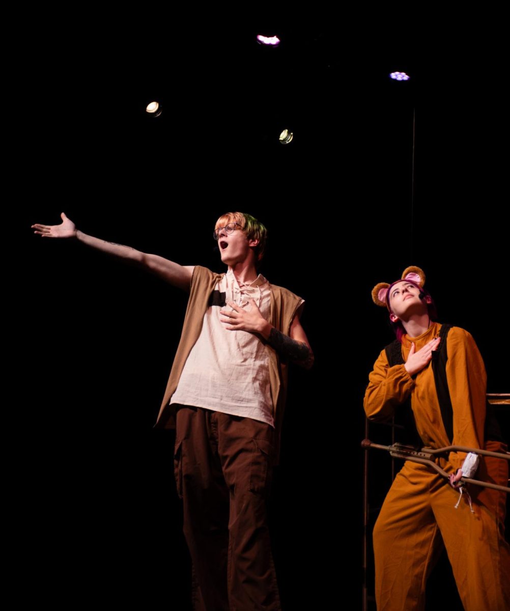 Thomas Weston ('25) and (Kira Mitchell ('26) pose onstage