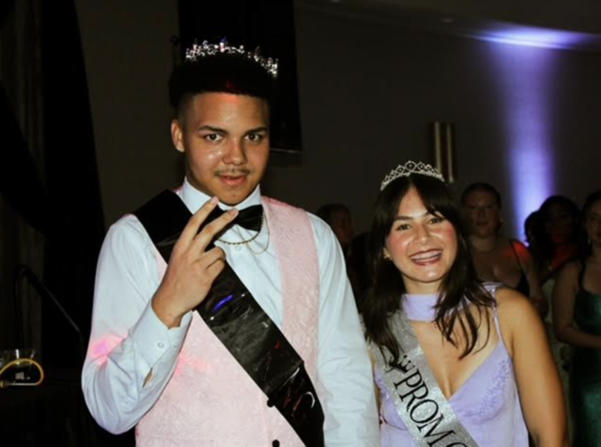 Malik and Noelle pose for the camera after being awarded.