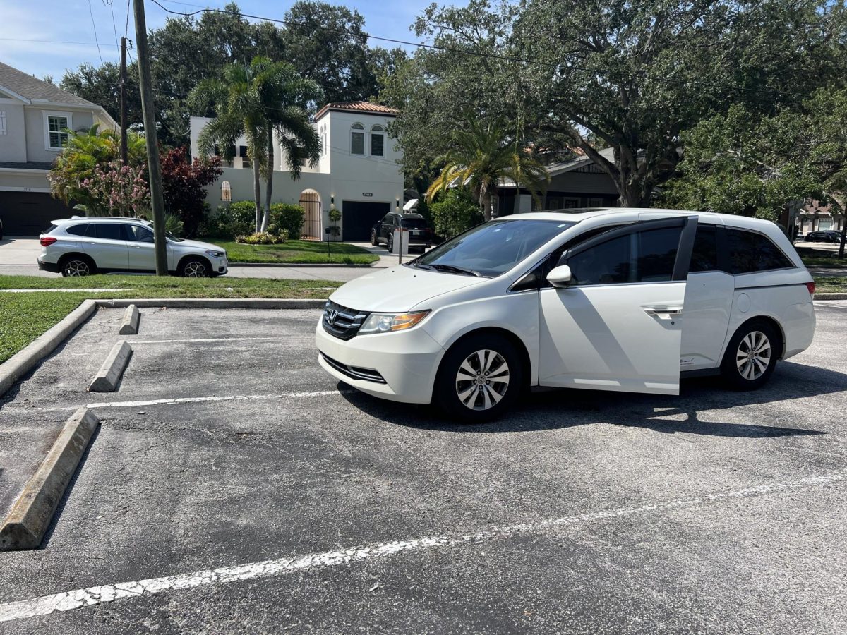 A very poorly parked car driven by a young teen.