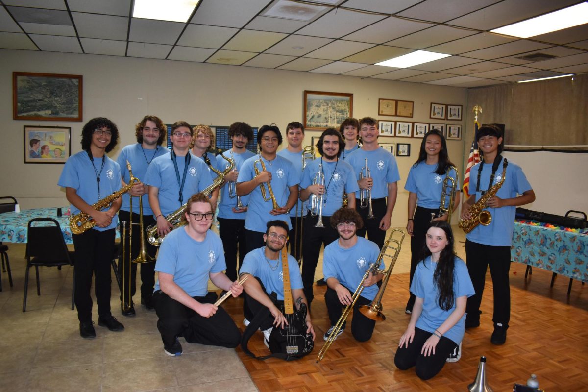  Band members pose with instruments before this summer's concert. 