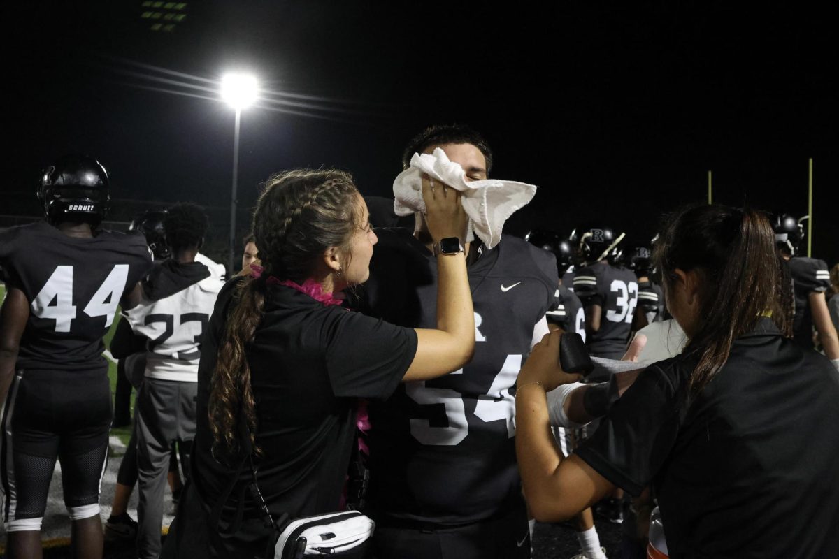 Lane Virgil ('27) and Sarah Williams ('27) tend to a football player mid-game.
