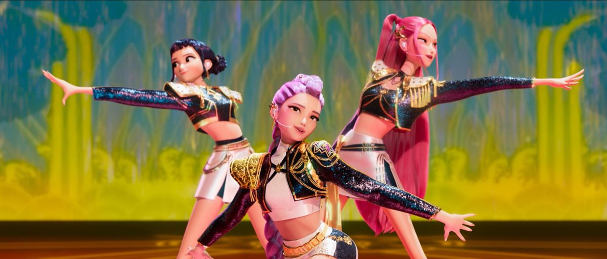 From left to right, Zoey (Ji-young Yoo), Rumi (Arden Cho), and Mira (May Hong), the members of Huntrix, are shown singing their hit single, "Golden."