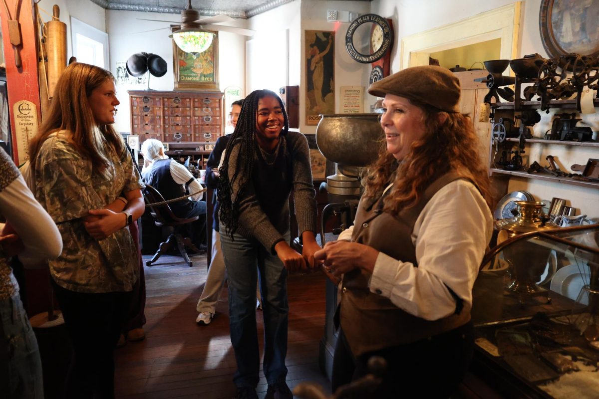 Lael Beal ('27) uses an old fashioned drink mixer at The Oldest Store.