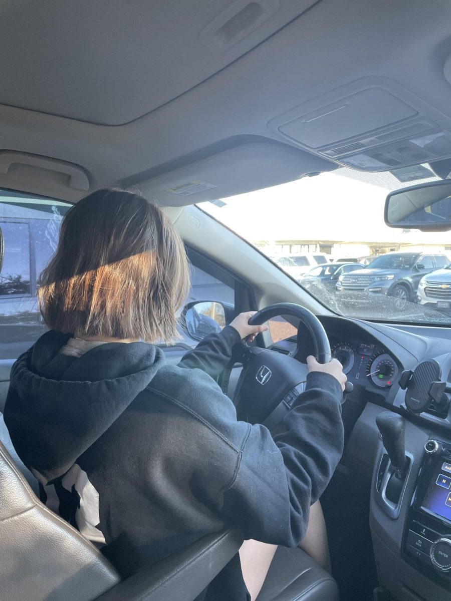A confused senior looks out at a full parking lot.