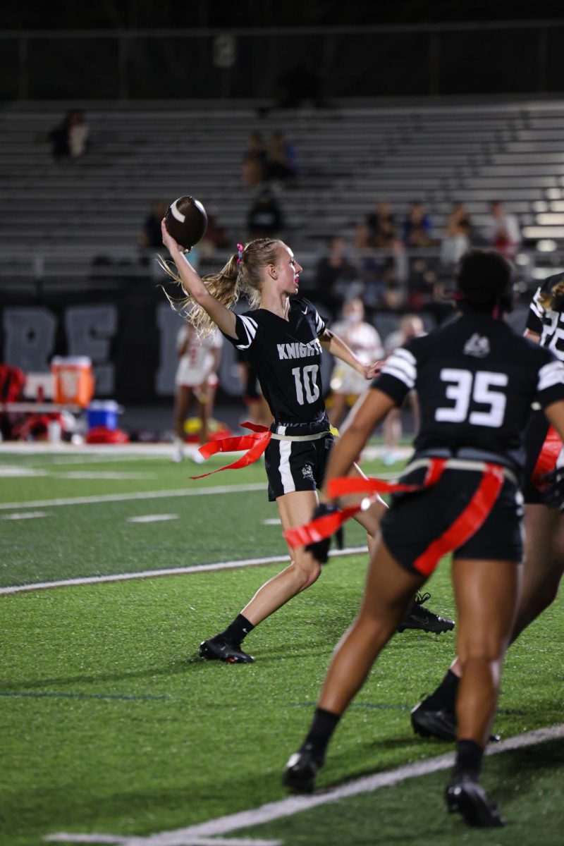 Paige Halverson ('26) throws the ball during an intense play.