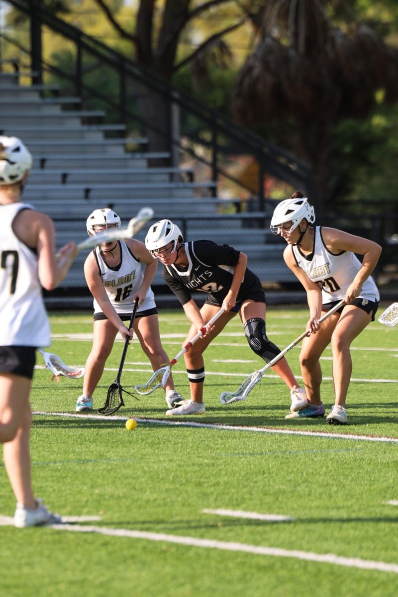 Ella Johnson ('27) fights for the ball against Plant.