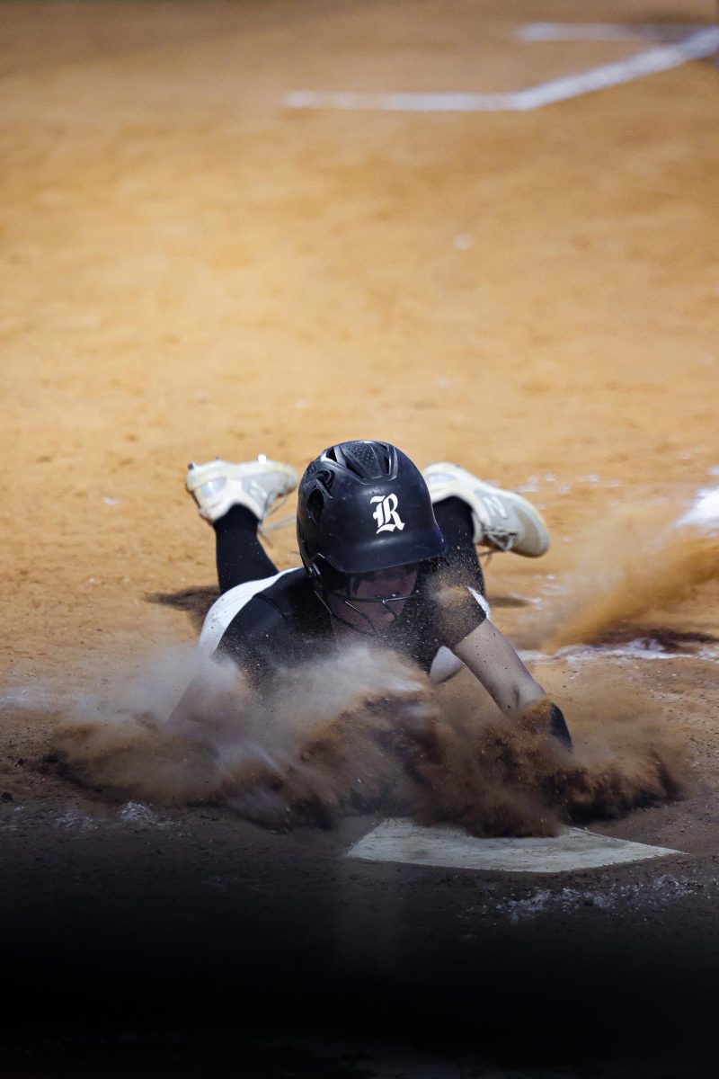 Eva Satin ('29) sliding onto home base after a tough play.