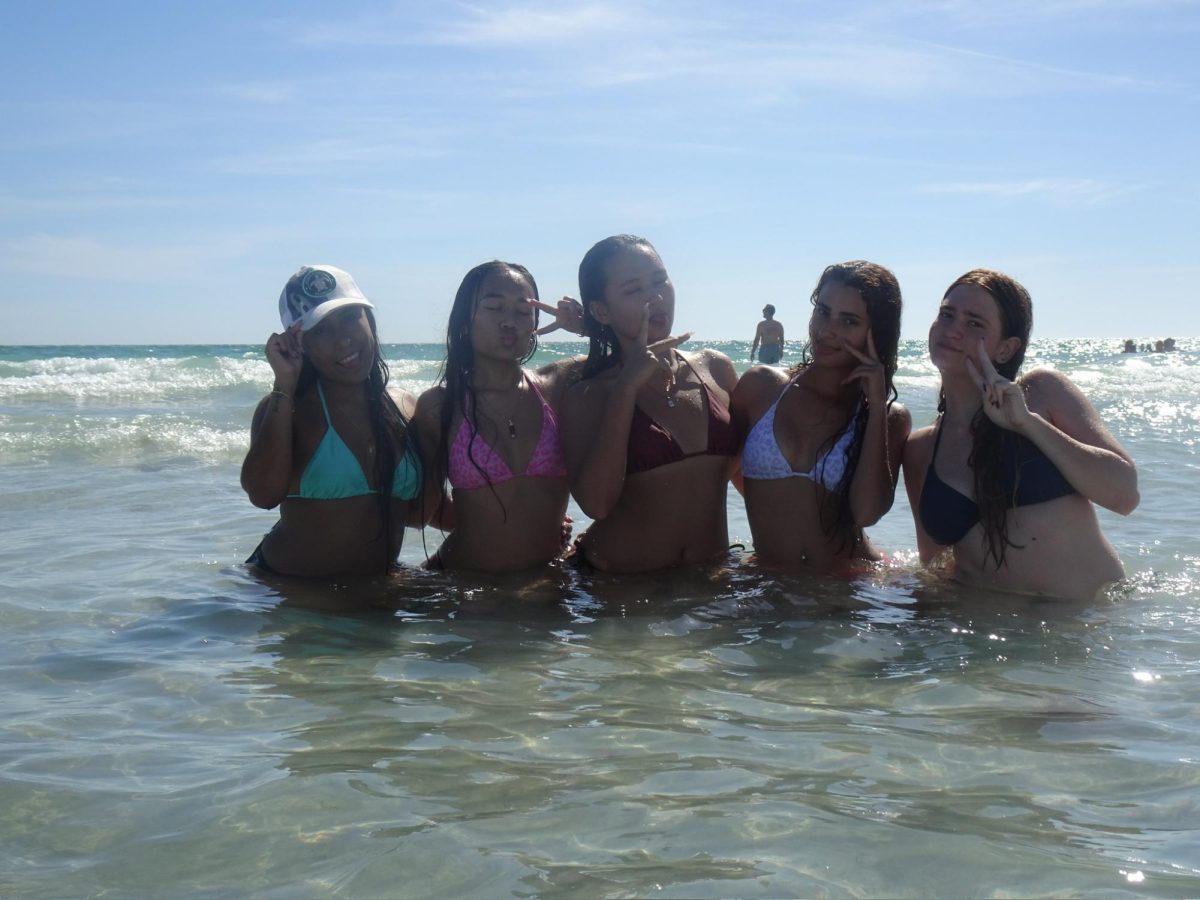High school students enjoy a sunny day out on the beach.