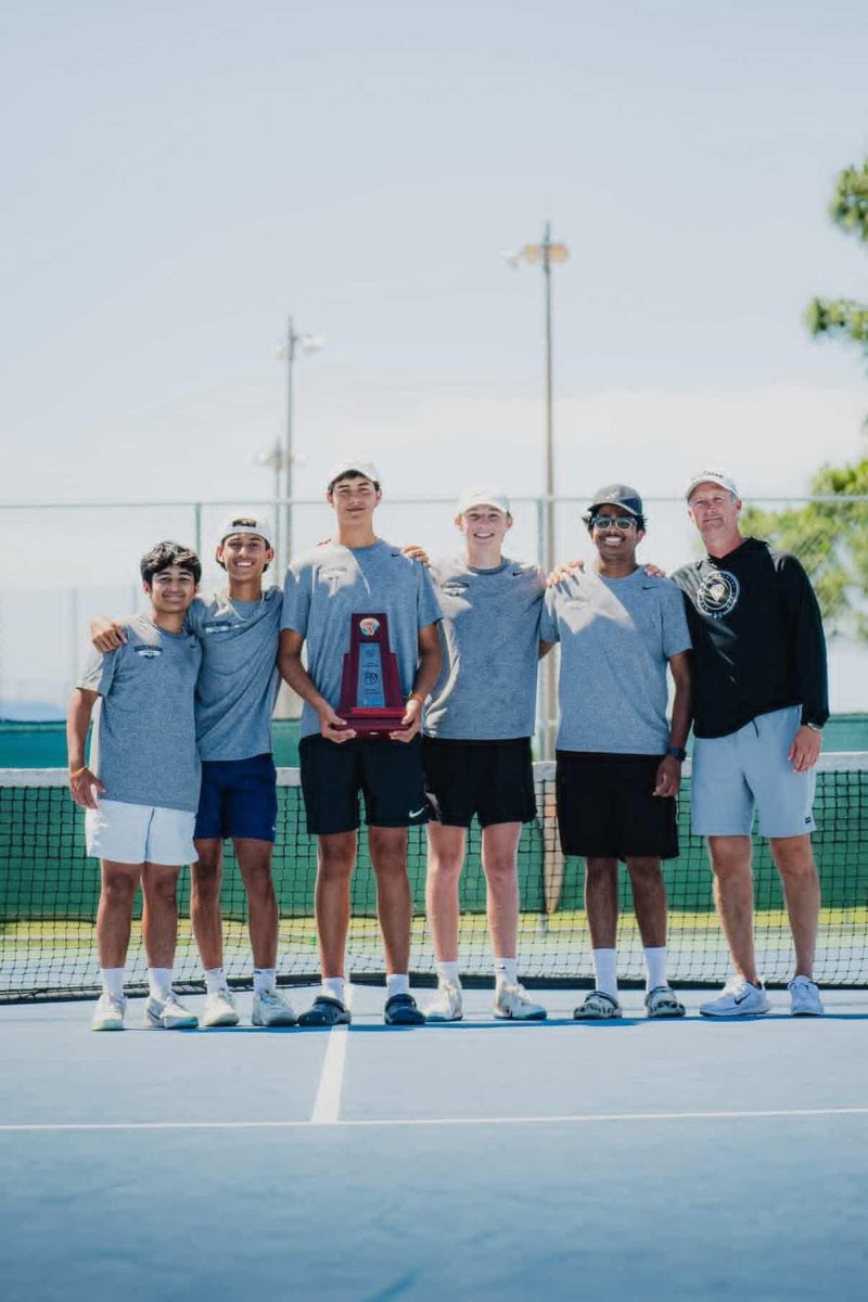 The Robinson boys tennis team posing for a picture after winning Districts 