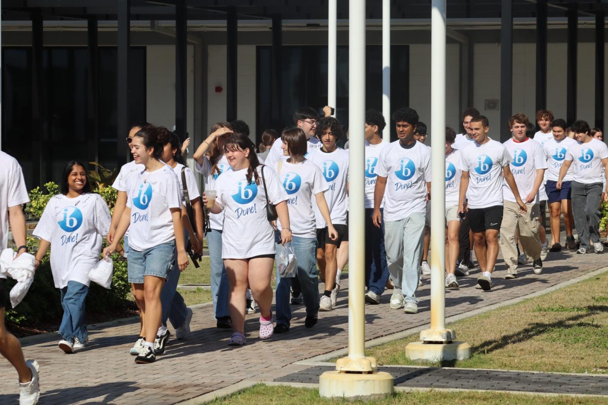 Ib seniors walking down the courtyard while getting clapped out