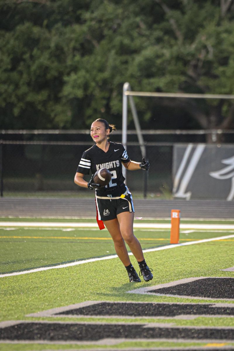 Sarah Williams ('27) running with the ball in the end zone