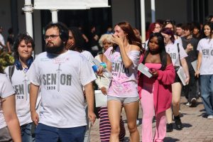 The seniors walking past all students during clap out