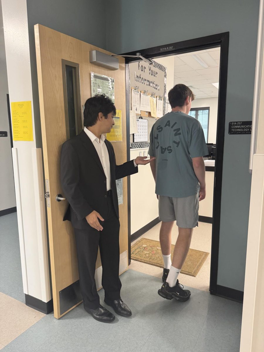 TJ Maiello ('27) kindly holds the door open for his classmate, Garrett Senzon ('27).